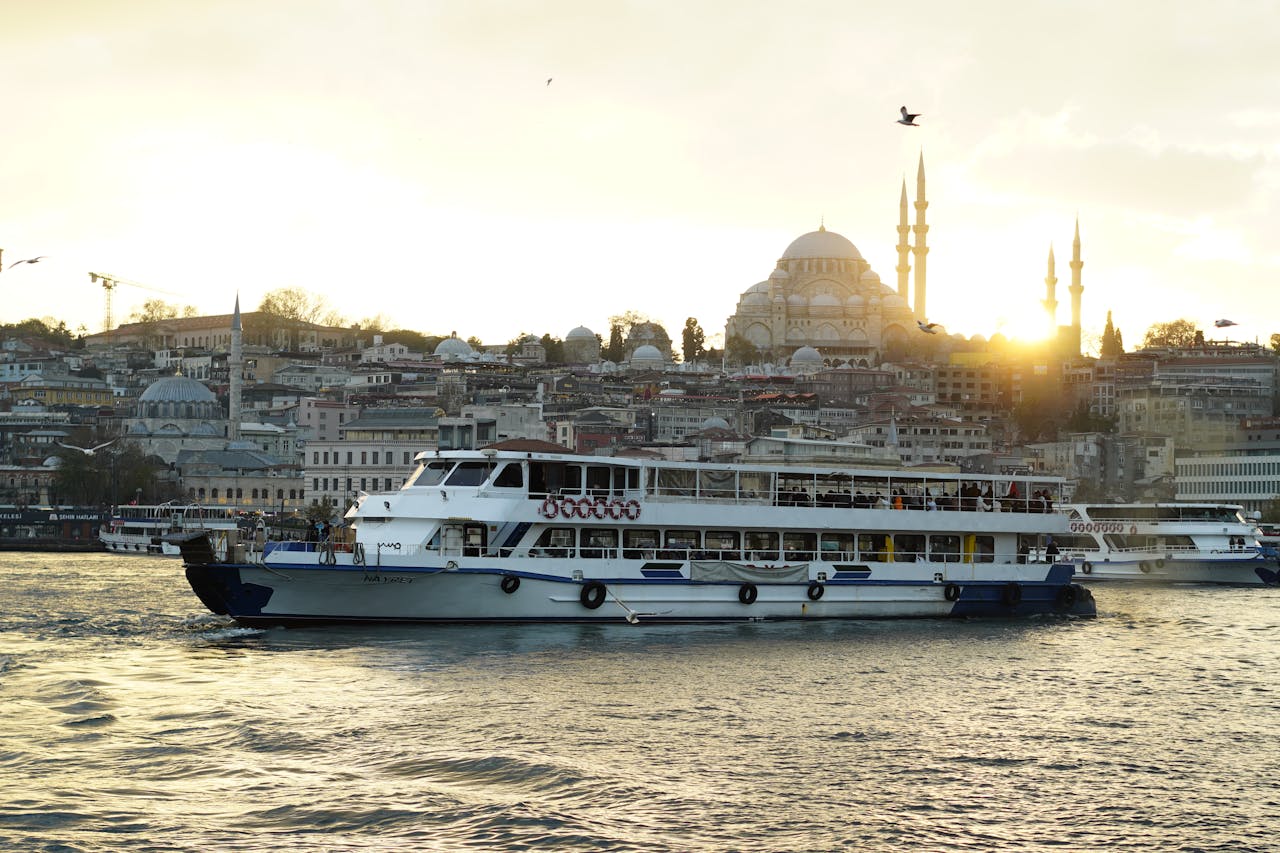 A scenic boat cruise on the Bosphorus with Istanbul’s skyline and a mosque at sunset.