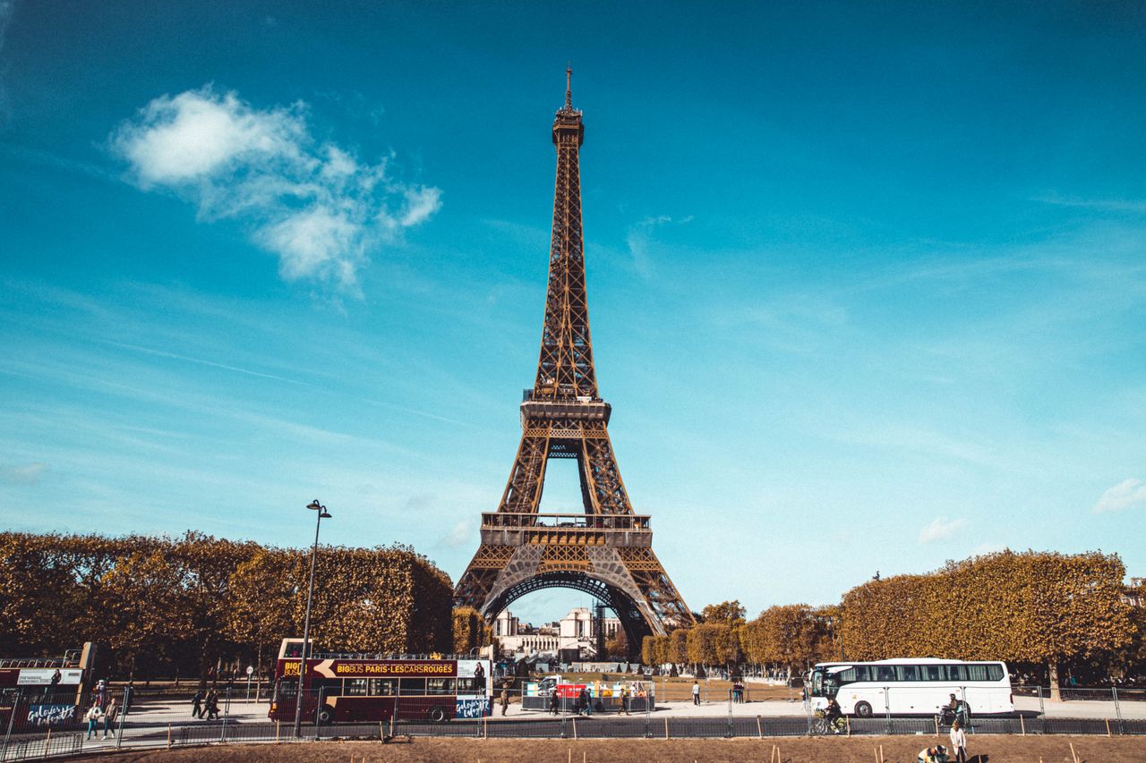 Stunning view of the Eiffel Tower in Paris under a clear blue sky, capturing the iconic landmark.